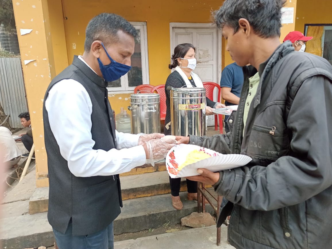Handing a plate of food to a person in need.