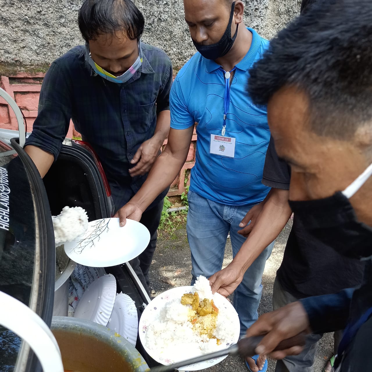 Serving rice and curry from the back of a car.