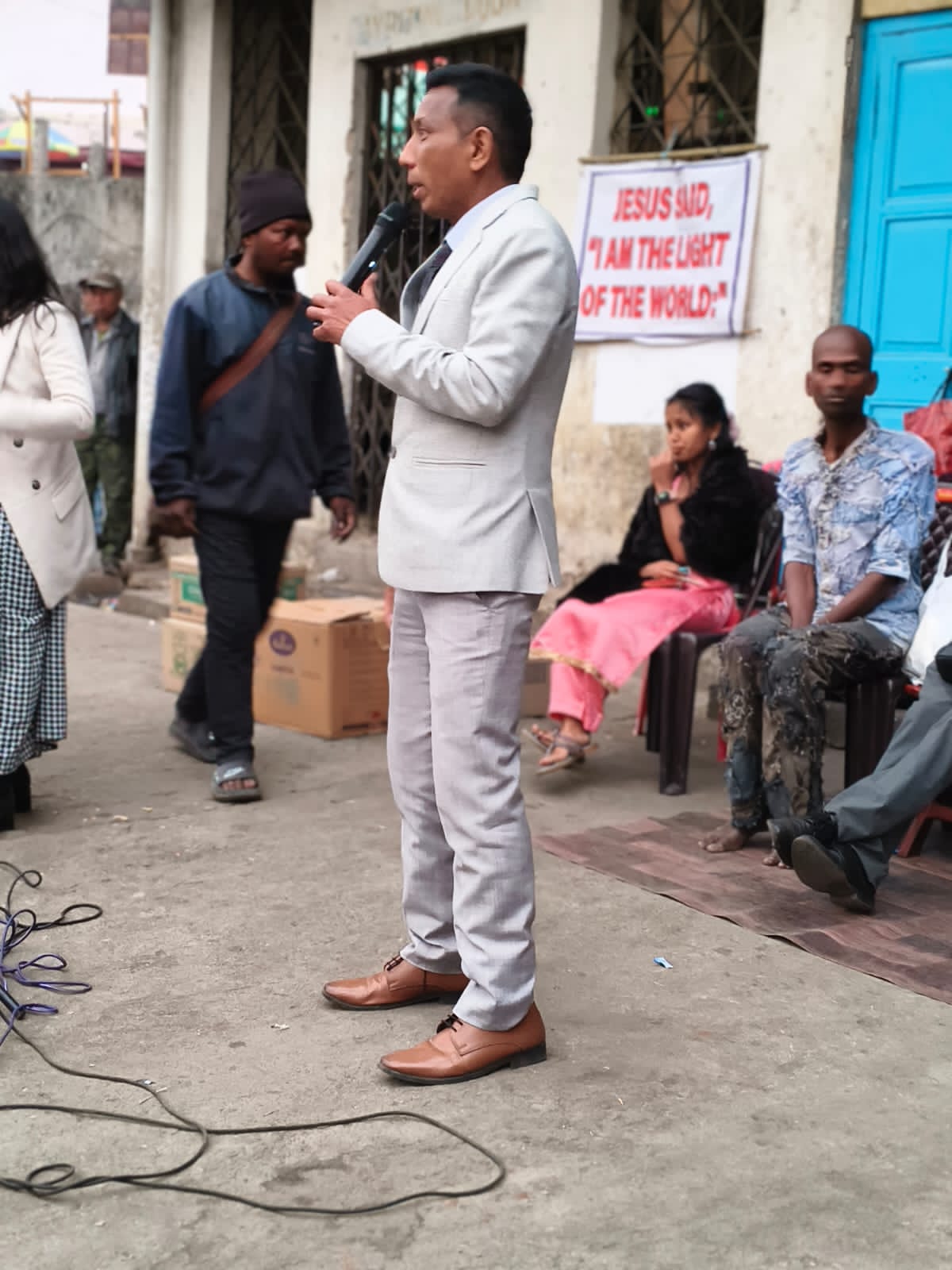 Street preaching to a small audience.