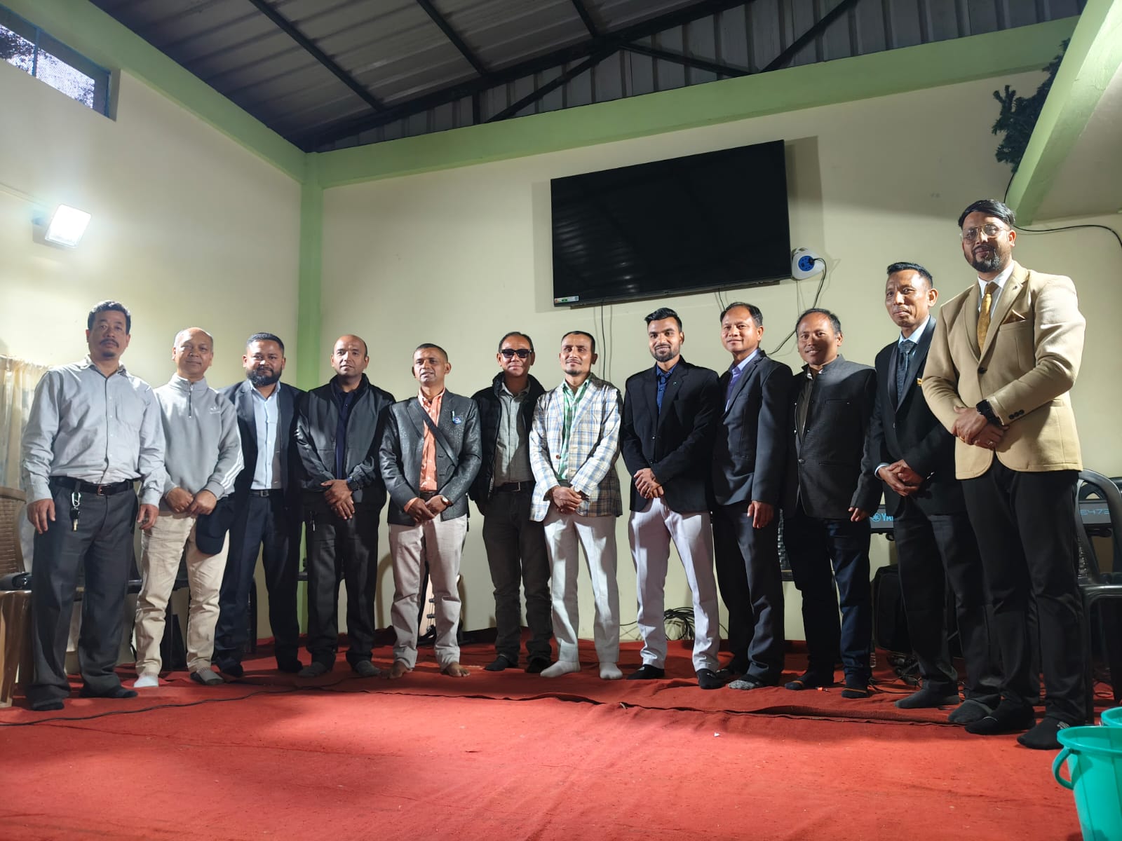 CMI team posing for a group photo on stage.