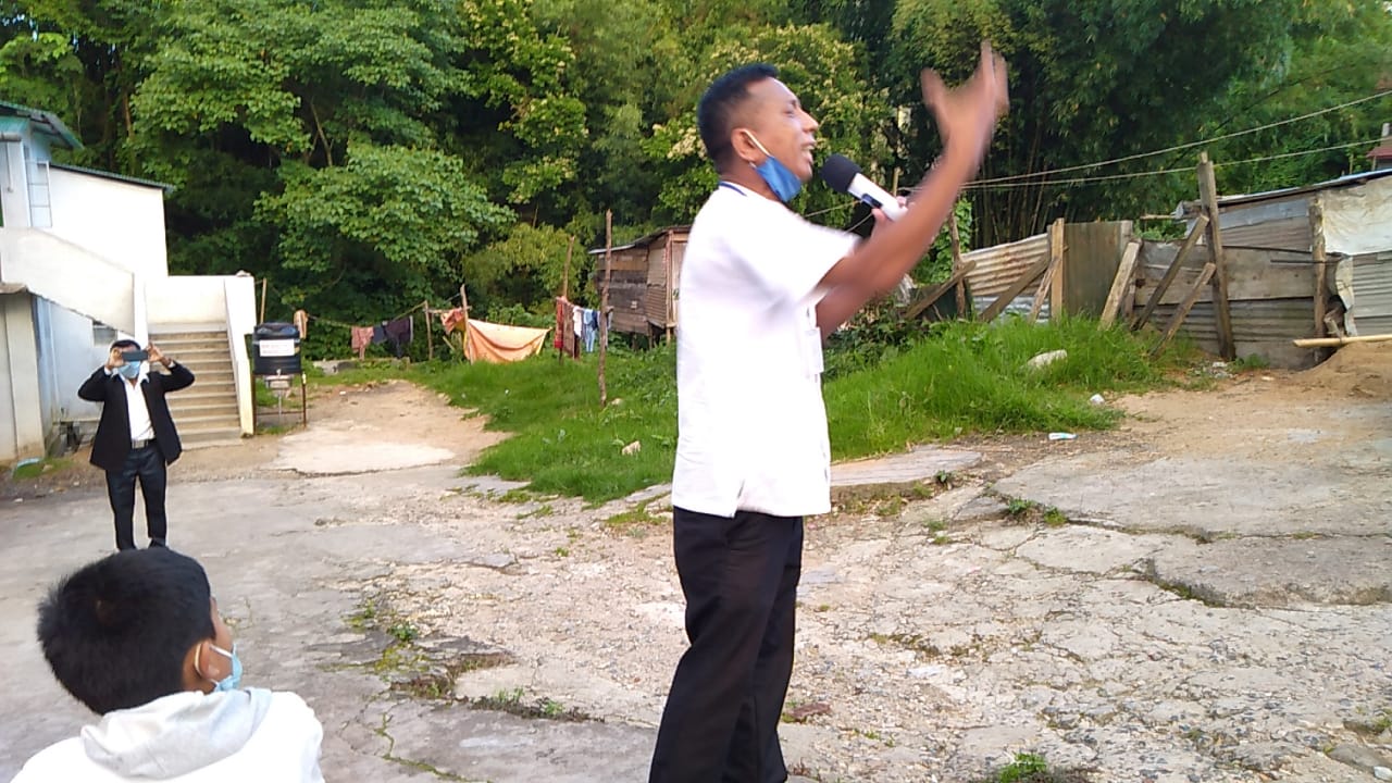 Speaking to a crowd in a residential area.