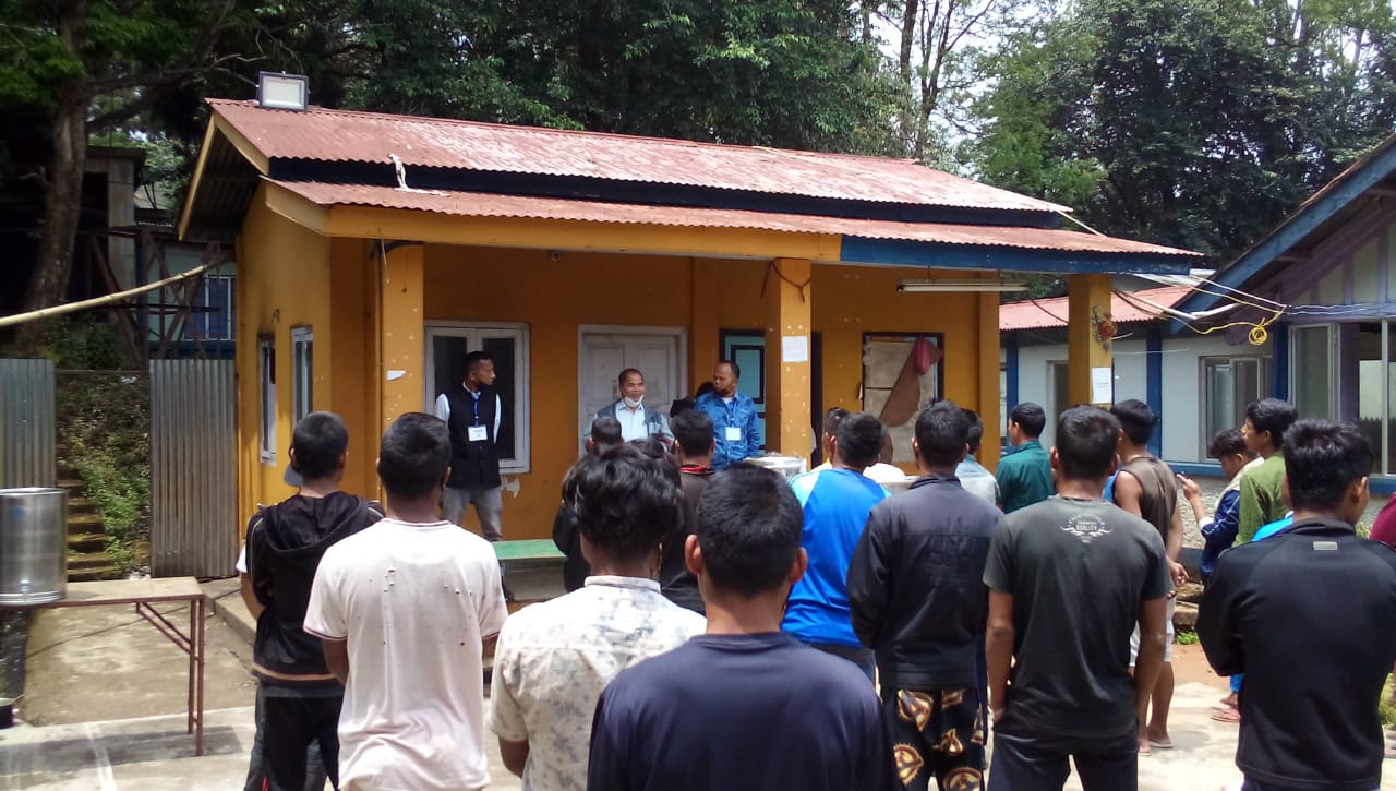 Addressing a crowd in a courtyard.