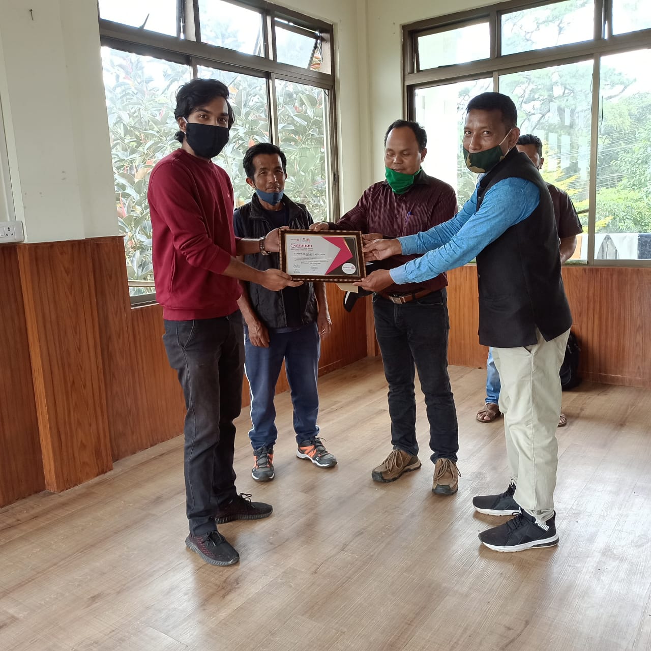 Receiving a framed certificate of appreciation.